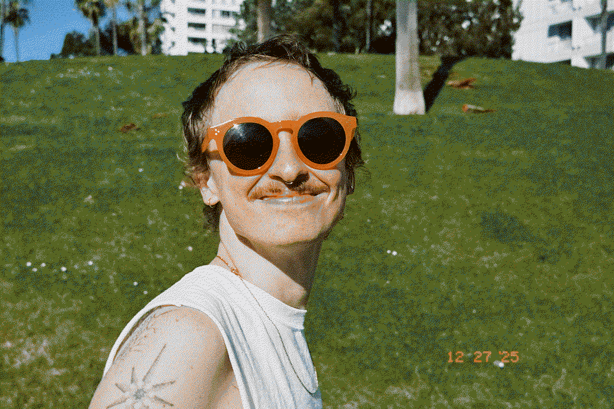 A dithered image of a beautiful man smiling at the beach in Santa Monica