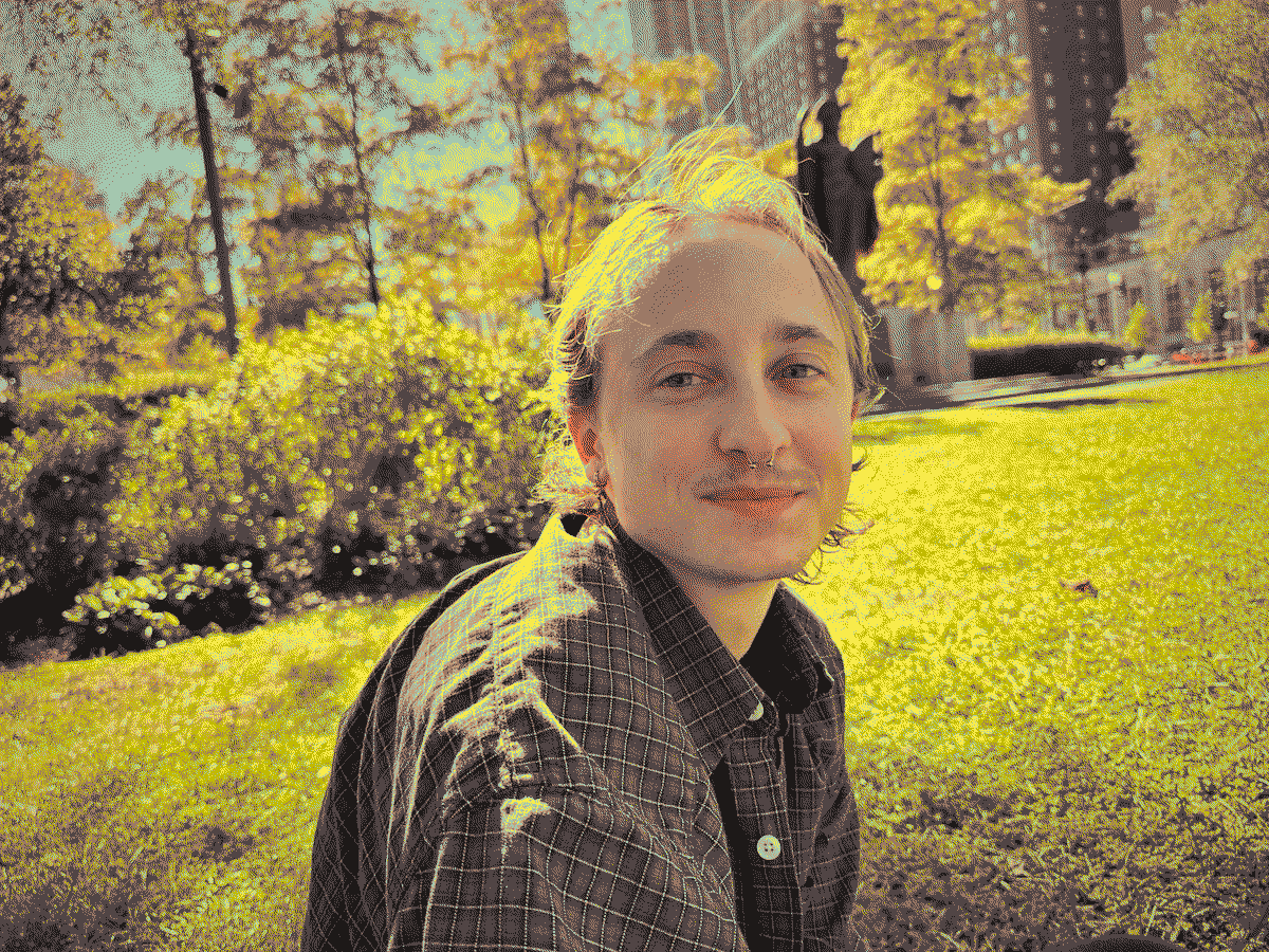 A dithered image of a beautiful man sitting in a park in downtown Chicago